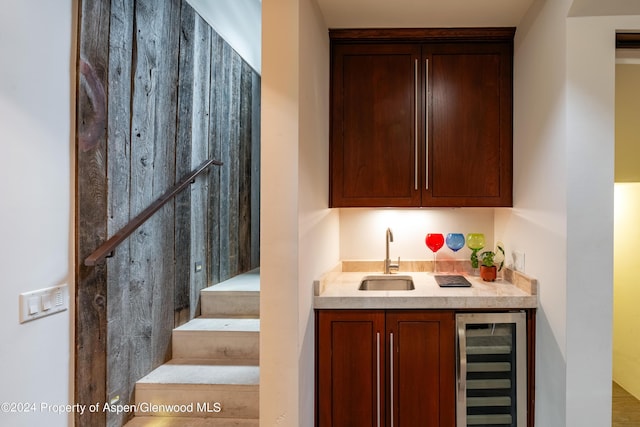 bar with wet bar, wine cooler, stairs, and a sink