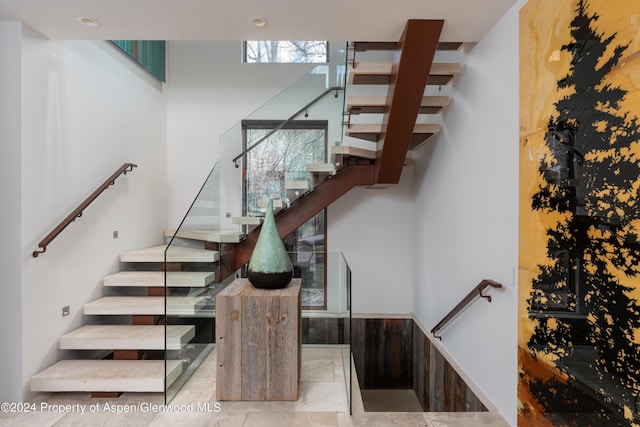 stairway featuring tile patterned floors