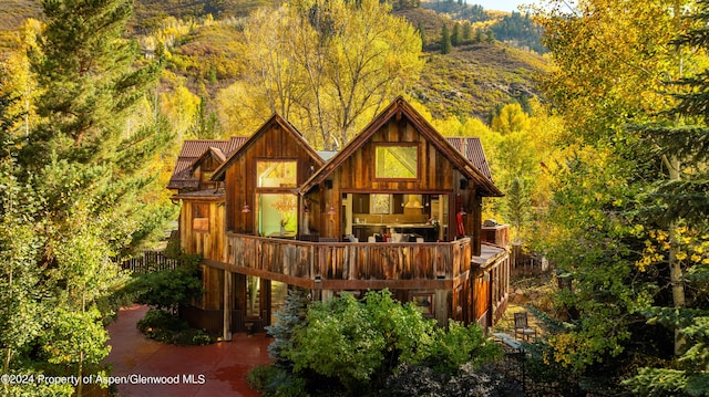 rear view of house with a wooded view