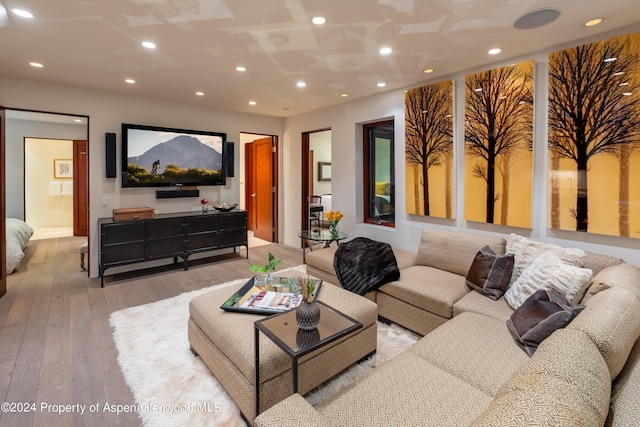 living area featuring hardwood / wood-style floors and recessed lighting