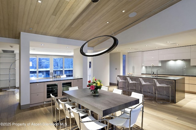 126 Juan St, Aspen, CO 81611 - dining area featuring light wood finished floors, wine cooler, recessed lighting, and wood ceiling