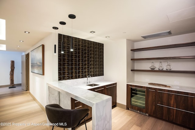126 Juan St, Aspen, CO 81611 - indoor wet bar featuring wine cooler, light wood finished floors, recessed lighting, and decorative light fixtures