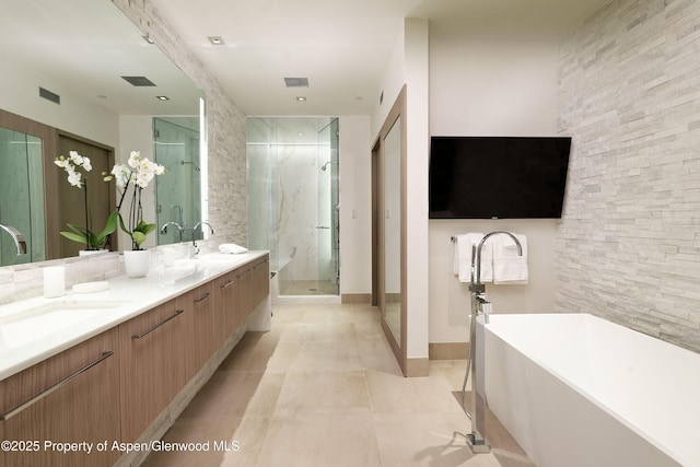 126 Juan St, Aspen, CO 81611 - bathroom with a freestanding bath, double vanity, a shower stall, and tile patterned flooring