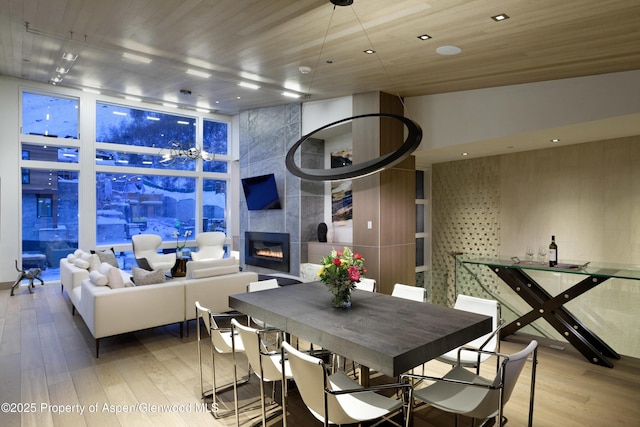 126 Juan St, Aspen, CO 81611 - dining space featuring wood finished floors, floor to ceiling windows, and a tiled fireplace