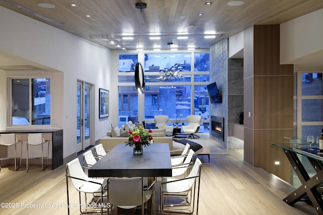 126 Juan St, Aspen, CO 81611 - dining room featuring wood finished floors, floor to ceiling windows, and a tile fireplace