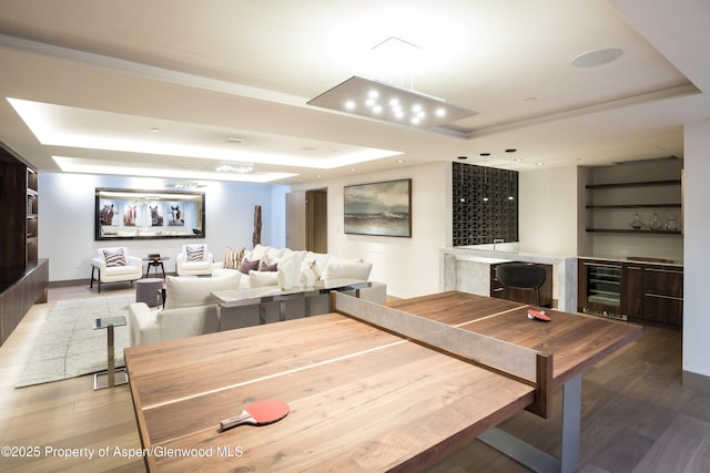 126 Juan St, Aspen, CO 81611 - recreation room with a tray ceiling, beverage cooler, bar area, wood finished floors, and recessed lighting