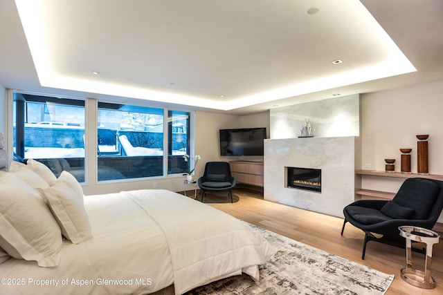 126 Juan St, Aspen, CO 81611 - bedroom with a raised ceiling, wood finished floors, and a high end fireplace