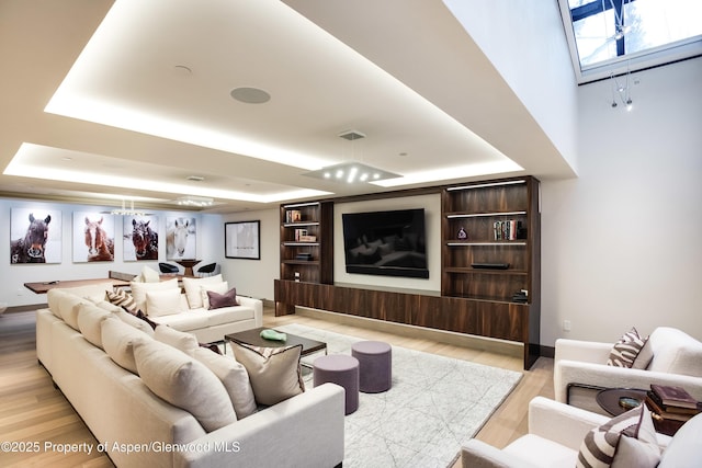 126 Juan St, Aspen, CO 81611 - living room featuring a raised ceiling, light wood-type flooring, and a skylight
