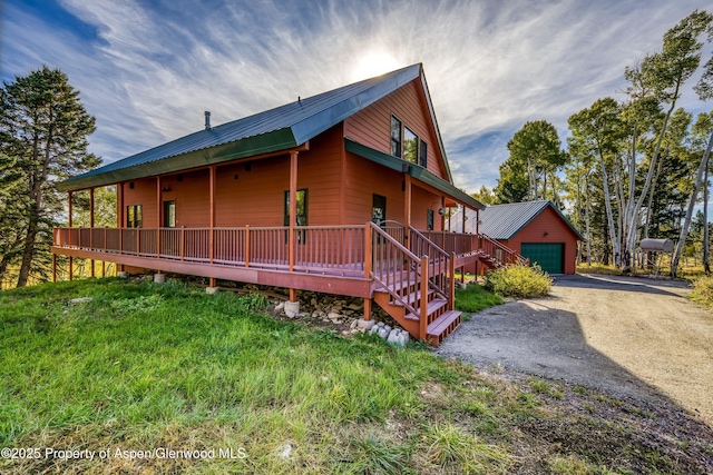 180 Ridge Rd, Gunnison, CO 81230 - view of home's exterior featuring a garage, an outdoor structure, metal roof, and driveway