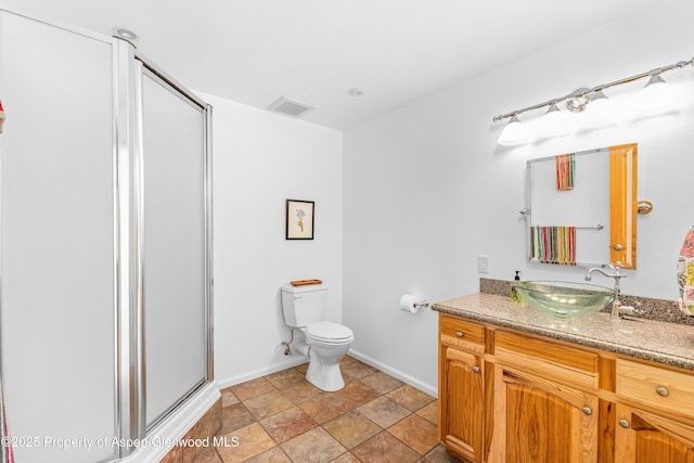 180 Ridge Rd, Gunnison, CO 81230 - bathroom featuring vanity, a shower stall, toilet, baseboards, and stone finish floors