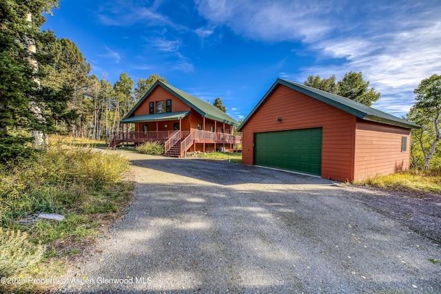 180 Ridge Rd, Gunnison, CO 81230 - chalet / cabin featuring an outbuilding, a garage, covered porch, and stairway