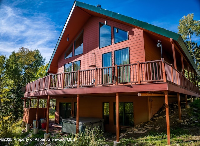 180 Ridge Rd, Gunnison, CO 81230 - rear view of house featuring a hot tub and a deck