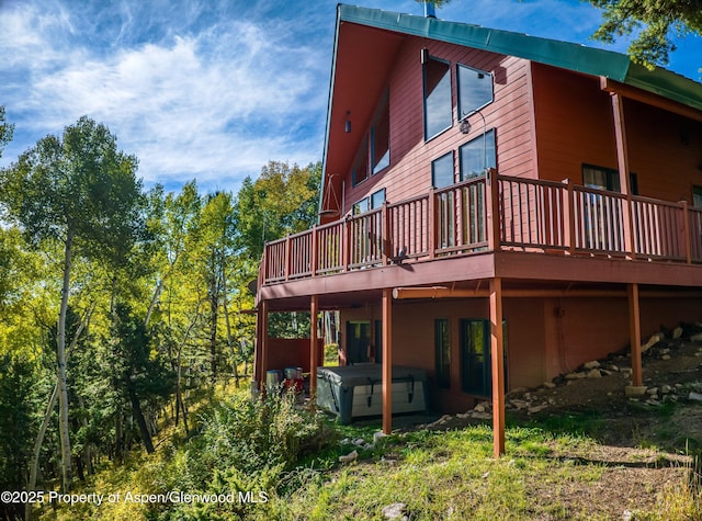 180 Ridge Rd, Gunnison, CO 81230 - rear view of house featuring a hot tub and a wooden deck