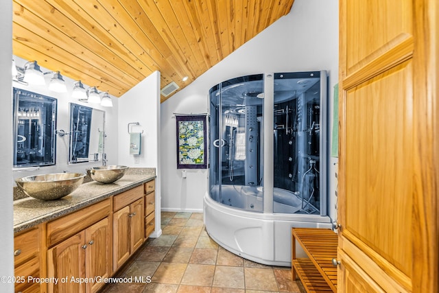 180 Ridge Rd, Gunnison, CO 81230 - bathroom featuring lofted ceiling, a whirlpool tub, wooden ceiling, double vanity, and baseboards