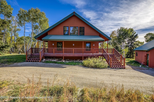 180 Ridge Rd, Gunnison, CO 81230 - rustic home with a porch, stairs, and metal roof