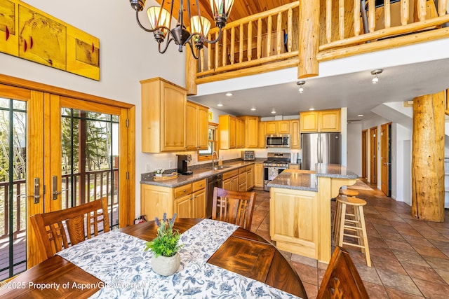 180 Ridge Rd, Gunnison, CO 81230 - kitchen with appliances with stainless steel finishes, a sink, a high ceiling, a chandelier, and french doors
