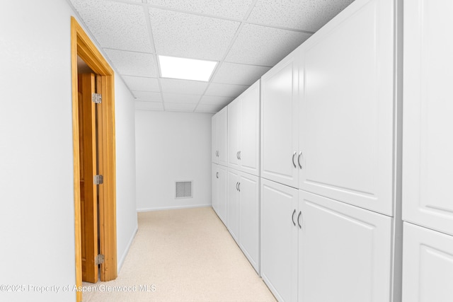 180 Ridge Rd, Gunnison, CO 81230 - hallway featuring a paneled ceiling, baseboards, and light carpet