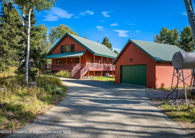 180 Ridge Rd, Gunnison, CO 81230 - chalet / cabin with a garage, a porch, metal roof, and an outdoor structure