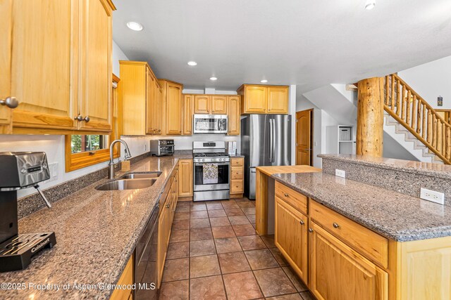 180 Ridge Rd, Gunnison, CO 81230 - kitchen featuring stainless steel appliances, a sink, stone countertops, recessed lighting, and a center island