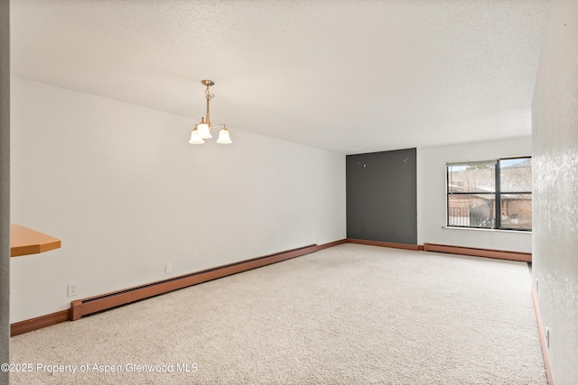 1527 Blake Ave Unit 209, Glenwood Springs, CO 81602 - spare room with a baseboard heating unit, a chandelier, carpet flooring, and a textured ceiling