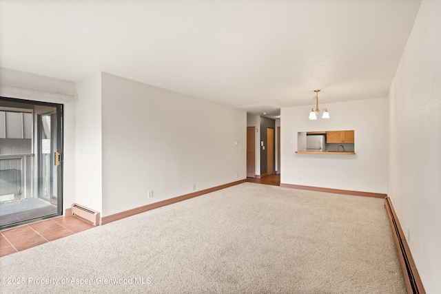 1527 Blake Ave Unit 209, Glenwood Springs, CO 81602 - carpeted spare room with a baseboard heating unit and a chandelier