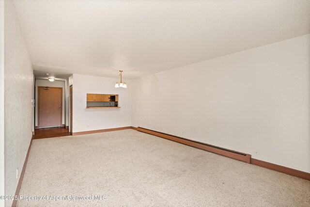 1527 Blake Ave Unit 209, Glenwood Springs, CO 81602 - empty room with a baseboard radiator and a chandelier