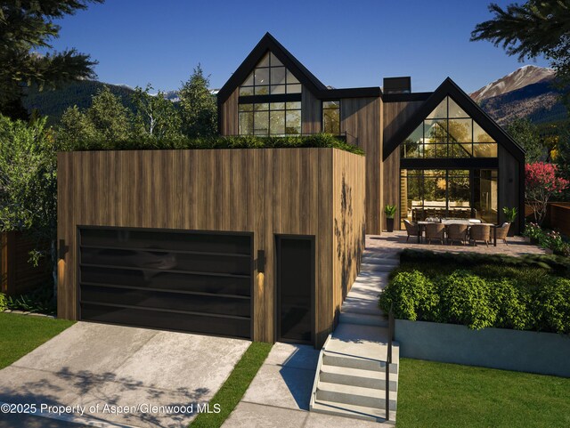 view of front of property with a mountain view and a garage