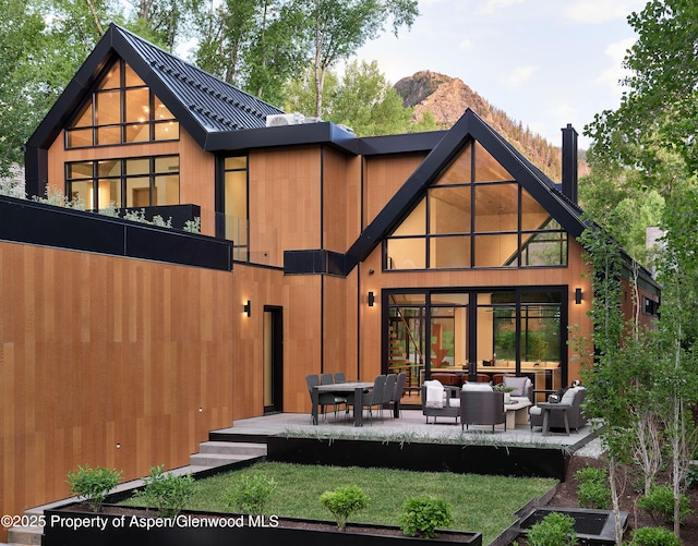 810 W Smuggler St, Aspen, CO 81611 - back of property with outdoor lounge area and a mountain view