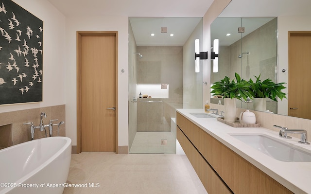 810 W Smuggler St, Aspen, CO 81611 - bathroom with a stall shower, a freestanding tub, and double vanity