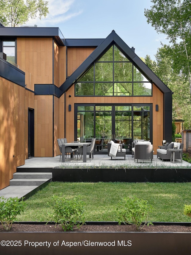 810 W Smuggler St, Aspen, CO 81611 - rear view of property featuring outdoor lounge area and a lawn