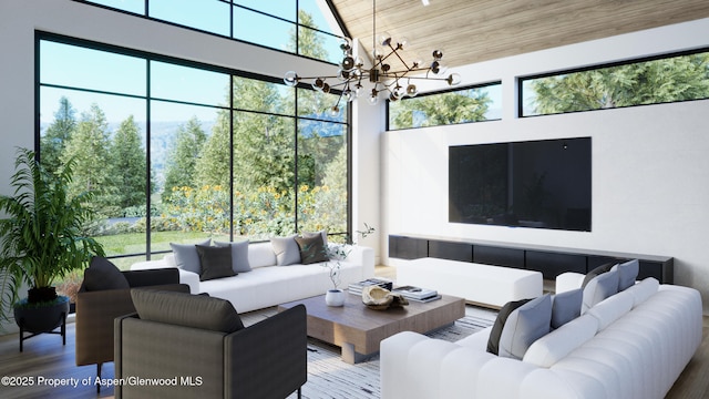 living room with high vaulted ceiling, a notable chandelier, and wood finished floors