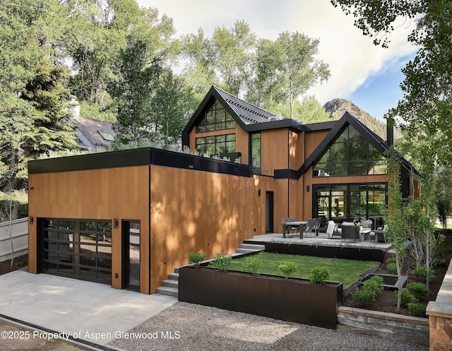 810 W Smuggler St, Aspen, CO 81611 - view of front of home featuring concrete driveway and an outdoor living space