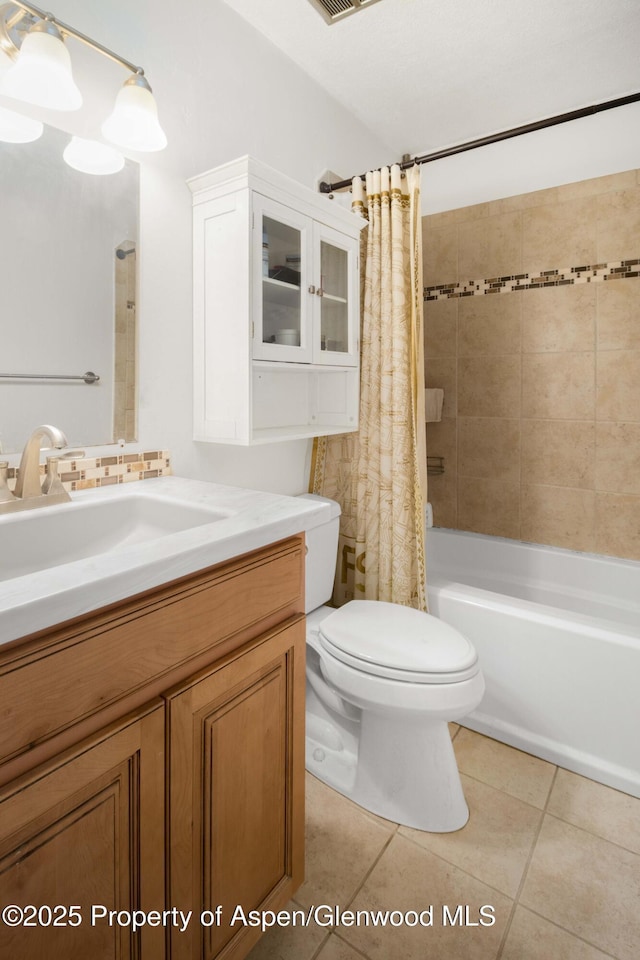 full bathroom with toilet, vanity, tile patterned floors, and shower / bath combo with shower curtain