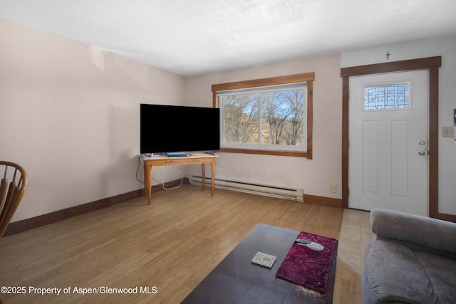 foyer with hardwood / wood-style floors and baseboard heating