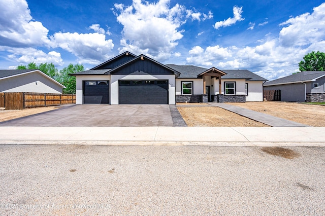 964 E 17th St, Rifle, CO 81650 - view of front of property featuring concrete driveway, an attached garage, stucco siding, and stone siding