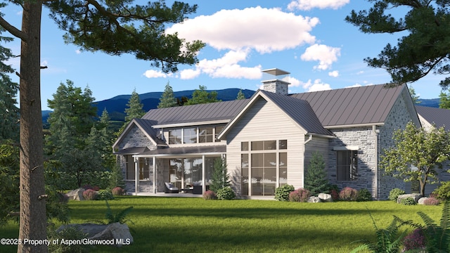 956 Bald Eagle Way, Carbondale, CO 81623 - back of house featuring a standing seam roof, a chimney, stone siding, and a lawn