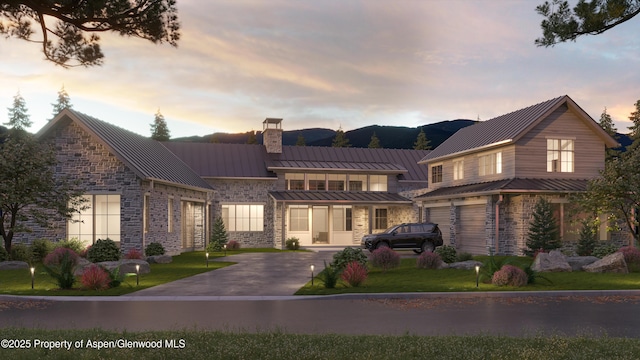 956 Bald Eagle Way, Carbondale, CO 81623 - view of front of home featuring a standing seam roof, stone siding, a chimney, and a metal roof