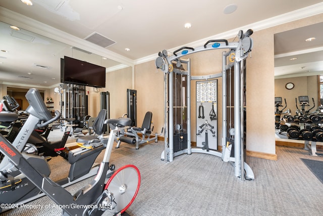 exercise room with carpet and ornamental molding