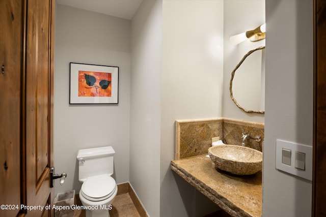 bathroom featuring tile patterned floors, toilet, and sink