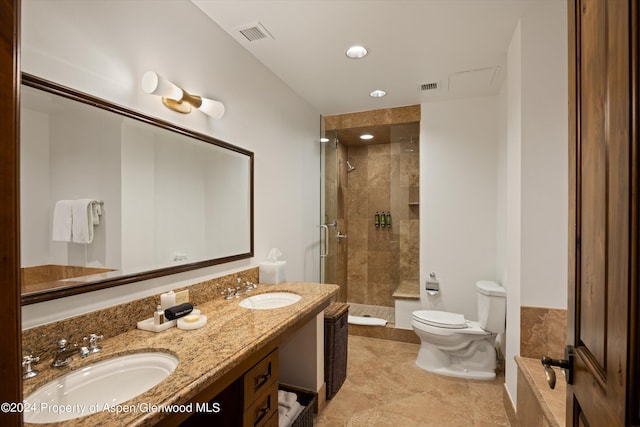 bathroom with tile patterned floors, vanity, an enclosed shower, and toilet