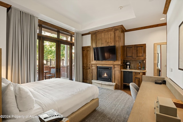 bedroom featuring access to exterior, french doors, sink, wood-type flooring, and a fireplace