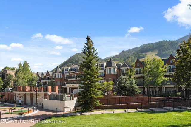 view of community featuring a mountain view and a yard