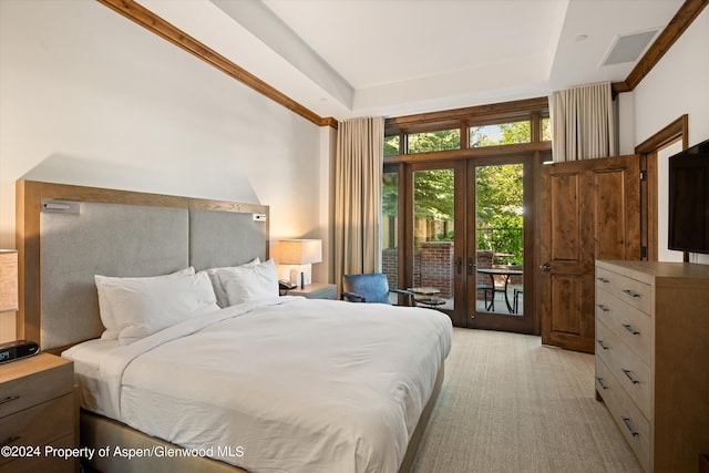 bedroom featuring a raised ceiling, access to outside, and french doors