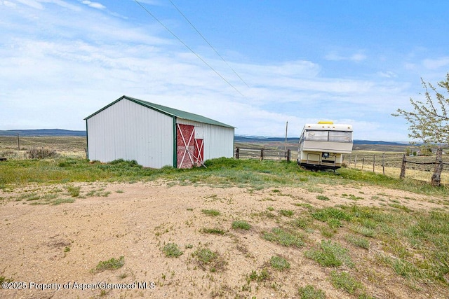 194 Hill Dr, Craig, CO 81625 - view of yard with fence, an outbuilding, an outdoor structure, and a rural view