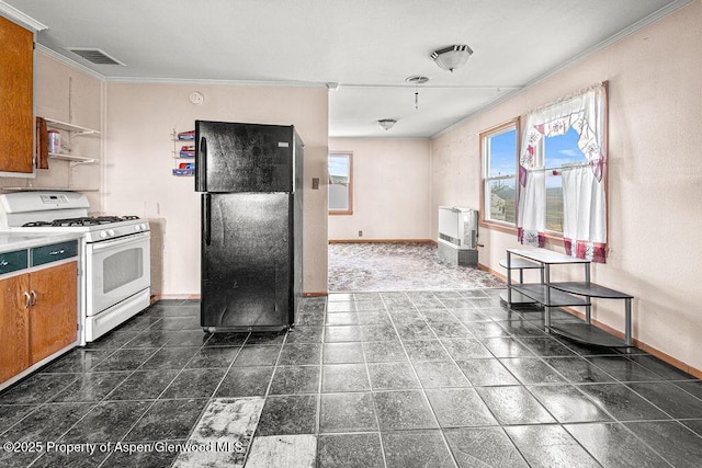 194 Hill Dr, Craig, CO 81625 - kitchen featuring white gas range, freestanding refrigerator, baseboards, crown molding, and brown cabinets