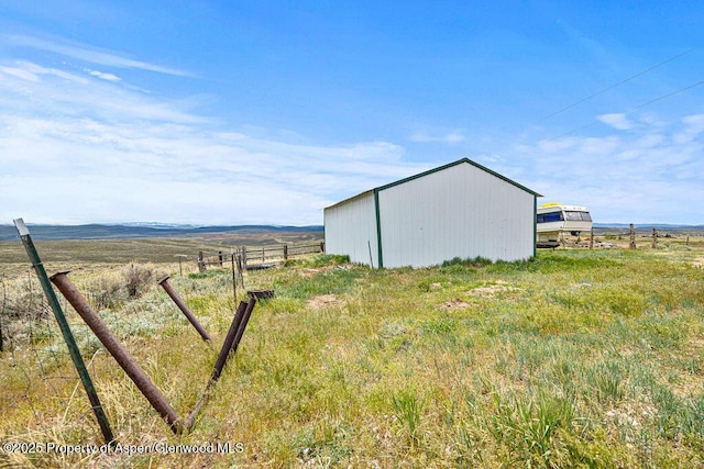 194 Hill Dr, Craig, CO 81625 - view of yard with an outbuilding, fence, and a view of rural / pastoral area