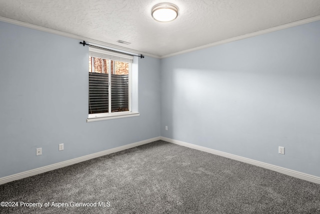 carpeted spare room with a textured ceiling and ornamental molding