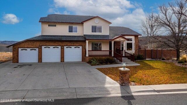 view of property featuring a garage and a front yard