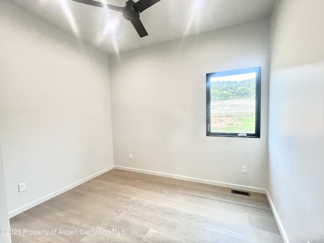 empty room with light hardwood / wood-style floors and ceiling fan