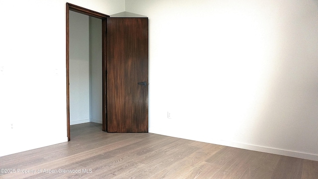 empty room with light hardwood / wood-style flooring